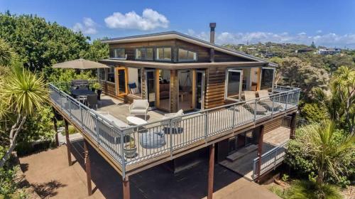 an aerial view of a house with a large deck at The Cove at Little O - Stay Waiheke in Oneroa