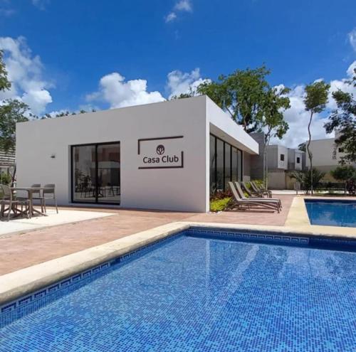 a building with a swimming pool in front of a building at Vacation Home in Playa Del Carmen in Playa del Carmen