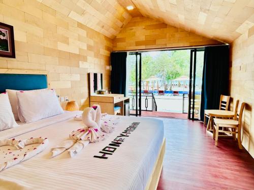 a bedroom with a bed with two swans on it at Royal C Resort in Koh Rong Island