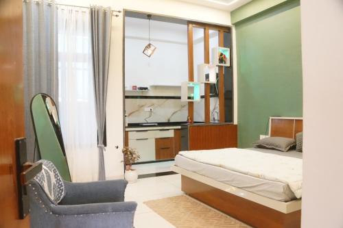a small bedroom with a bed and a chair at Meg's Homestay in Jairāmpura