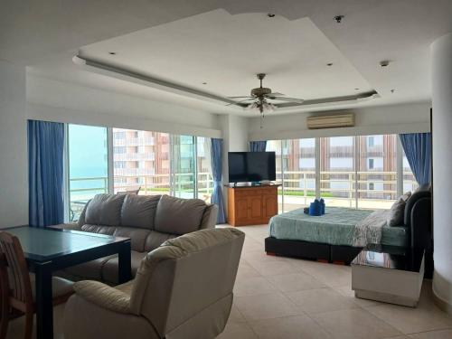 a living room with a couch and a bed and a tv at View Talay 6 Pattaya Beach by Anatolia Condo Suite in Pattaya Central