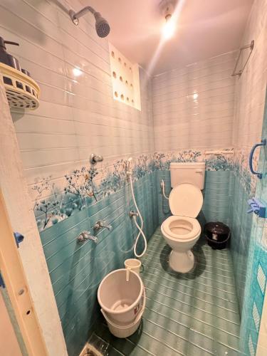 a bathroom with a toilet and a bidet at Casa Fiesta Pondy in Pondicherry
