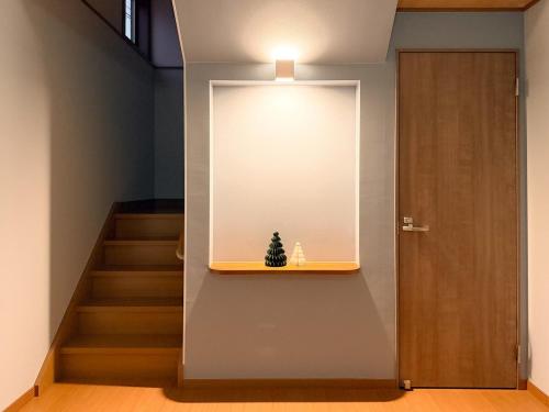 a staircase with a small christmas tree on a shelf at 新規オープン 越後湯沢駅徒歩4分 スキー場アクセス抜群 最大14名 Snowtopia in Yuzawa