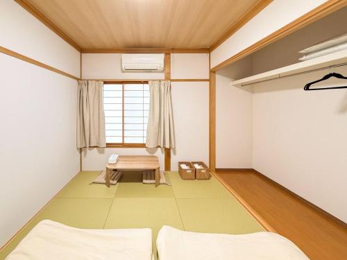 a room with a table and a bench in it at 新規オープン 越後湯沢駅徒歩4分 スキー場アクセス抜群 最大14名 Snowtopia in Yuzawa