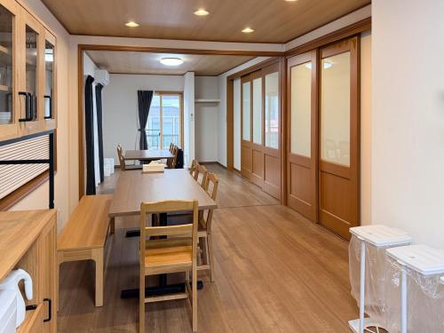 a dining room with a table and chairs at 新規オープン 越後湯沢駅徒歩4分 スキー場アクセス抜群 最大14名 Snowtopia in Yuzawa