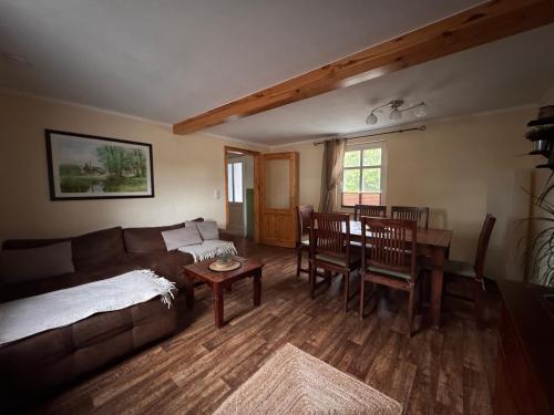 a living room with a couch and a table at Ferienhaus Layla in Leipe