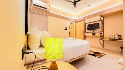 a hotel room with a bed and a television at Hotel Nova Wave in Rajkot
