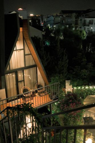 a balcony of a house with a table and chairs at Bach Place Dalat in Da Lat
