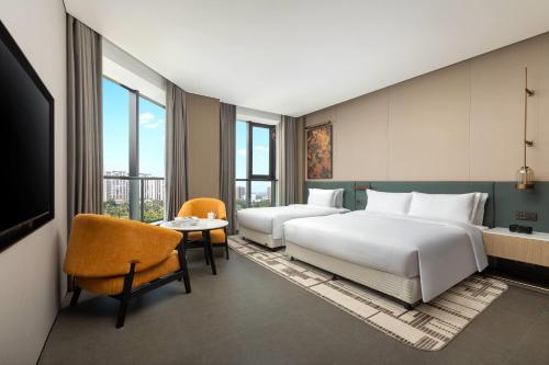 Ένα ή περισσότερα κρεβάτια σε δωμάτιο στο Days Hotel by Wyndham Haikou Meilan Airport