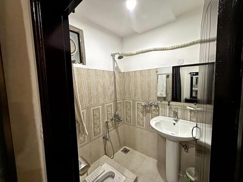 a small bathroom with a sink and a toilet at the best stay hotel in peshawar in Peshawar