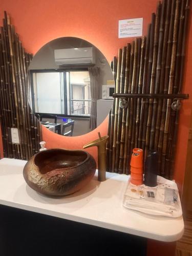 a toilet sitting on a counter in front of a mirror at Pine Leaf lnn 楓の宿 2号館 in Osaka