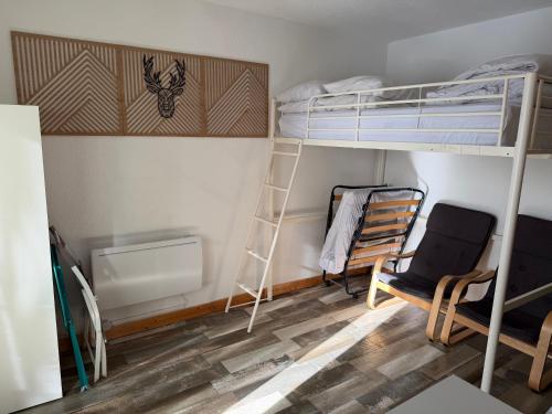 a room with a bunk bed and a chair at STUDIO LES JONQUILLES in Les Angles
