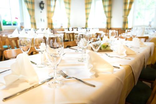 a row of tables with wine glasses and napkins at Gasthof zum Lamm in Gomadingen