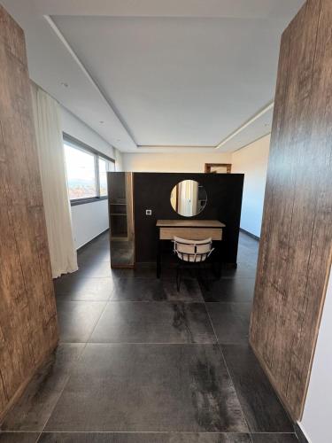 an empty room with a table and a window at Prestige home in Et Tnine Oudaya