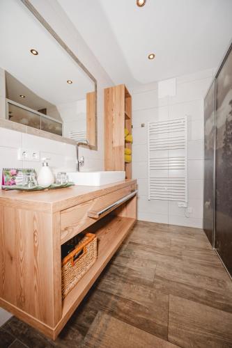 a bathroom with a sink and a mirror at Appartements Millinger in Lofer