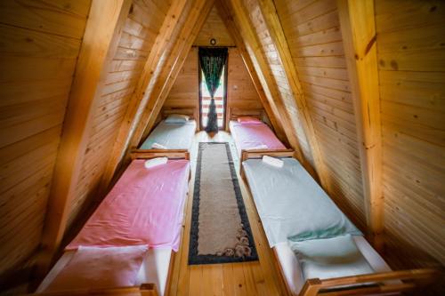 an overhead view of three beds in a wooden cabin at Una Relax in Vajagići