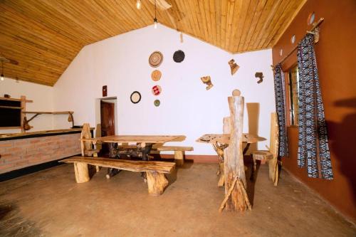 Habitación con mesa, banco y pared en Teryet Safari Lodge, en Kapchorwa