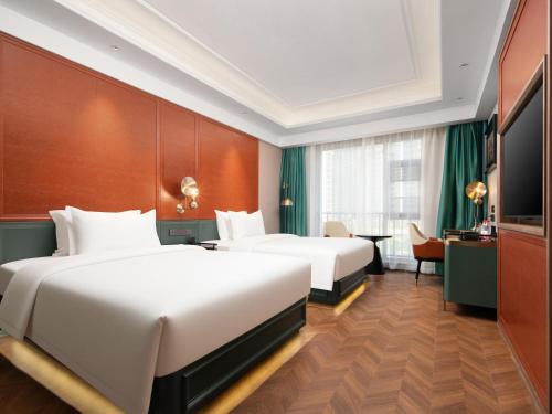 Postel nebo postele na pokoji v ubytování Wuhan International Plaza