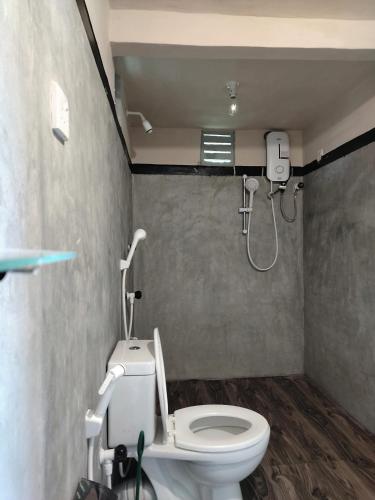 a bathroom with a toilet and a shower at Rainforest Nature House in Deniyaya