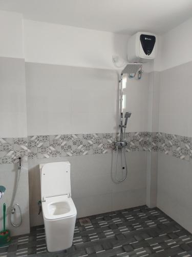 a bathroom with a toilet and a shower at Villa Pabasara in Talpe