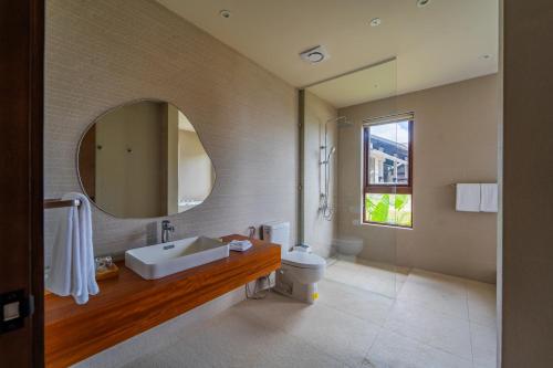 a bathroom with a sink and a mirror at Cebu Beach Club in Argao