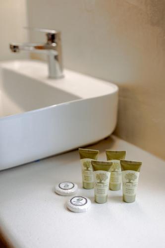 a group of four cups on a counter next to a sink at karion houses in Synikia Mesi Trikalon