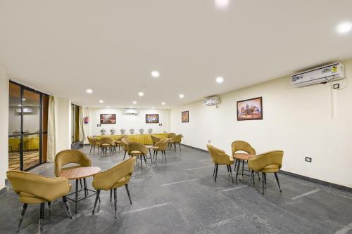 a large room with chairs and tables and a classroom at FabHotel Prime The Aroma in New Delhi