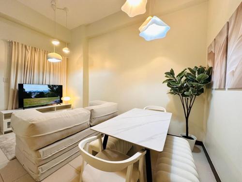 a living room with a couch and a table at Cloud Cinema by Kozy Mood near BGC in Manila