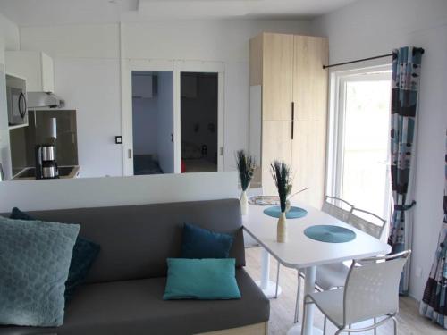 a living room with a couch and a table at Modern 6-person chalet in the Frisian countryside, 3 bedrooms and WiFi in De Veenhoop