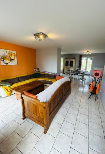 a bedroom with a large bed and a living room at Le HAMEAU 1936 Gîte des Milanaïs in Cherveux