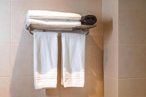 a group of towels hanging on a rack in a bathroom at Cityscape Luxury Suites in Plovdiv