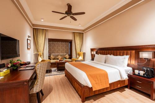 a hotel room with a bed and a desk at Jajati Courtyard in Jajpur Road