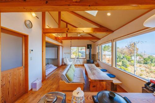 a room with a couch and a table in a house at きらぼしの里 大室高原 in Ito