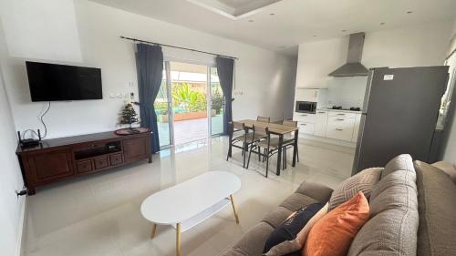 a living room with a couch and a table at Villa Sun 4 in Mae Nam