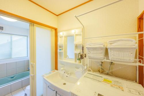 a bathroom with a sink and a mirror at きらぼしの里 大室高原 in Ito