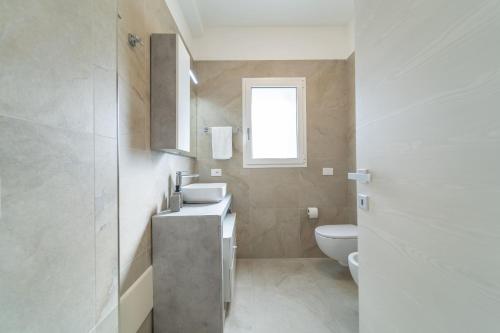 a bathroom with a sink and a toilet at Brorent A & L apartment B in Golfo Aranci