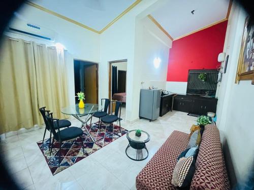 a living room with a couch and a table at Tropical VIBES RETREAT in Calangute