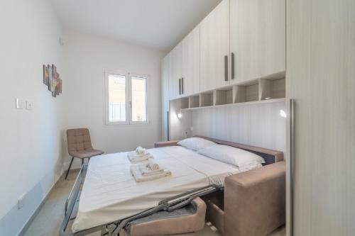 a room with a bed and a chair in it at Brorent A & L apartment T in Golfo Aranci