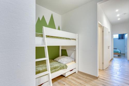 a bedroom with a bunk bed with a ladder at Alte Teestube Schmidt 59 Rechts in Norderney