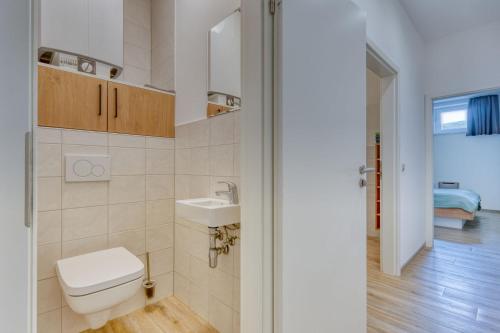 a small bathroom with a toilet and a sink at Alte Teestube Schmidt 59 Rechts in Norderney