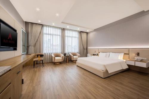 a hotel room with a large bed and a flat screen tv at A25 Premium Hotel - 705 Lac Long Quan in Hanoi