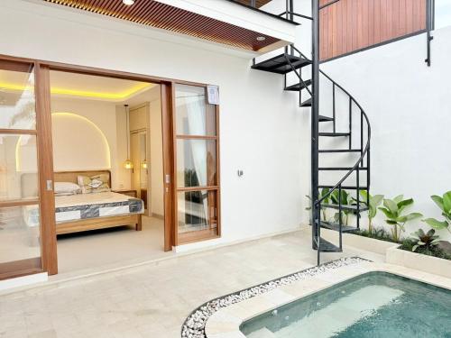 a house with a swimming pool and a bedroom at Villa in the Heart of Pererenan Prime Location in Munggu