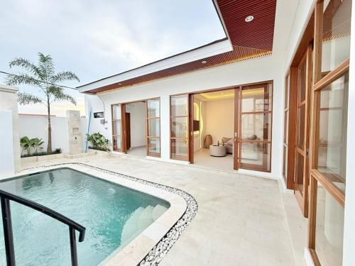 a swimming pool in the backyard of a house at Villa in the Heart of Pererenan Prime Location in Munggu