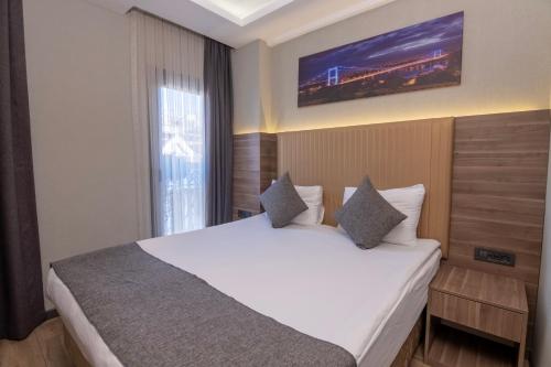 a hotel room with a large bed in a room at The Omiya Hotel in Istanbul