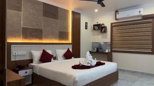 a hotel room with two beds and a television at Cloud9 Airport Hotel in Nedumbassery