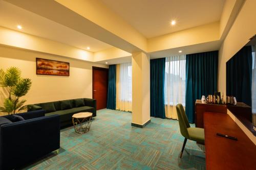 a living room with a couch and a table at Hotel Classic Pavilion in Trivandrum