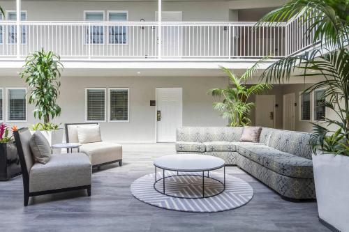 a living room with a couch and two chairs and a table at Inn Off Capitol Park, an Ascend Collection Hotel in Sacramento