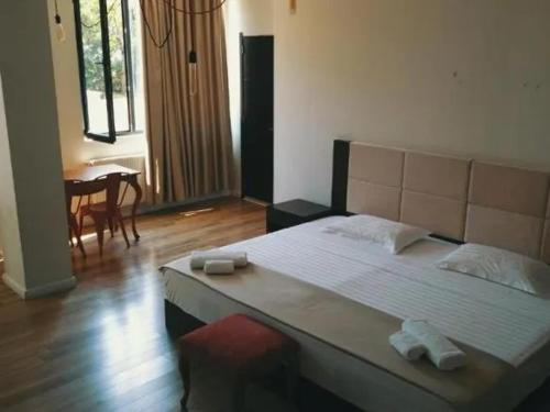 a bedroom with a large bed with two towels on it at Belgrad Rustaveli Kobuleti in K'obulet'i