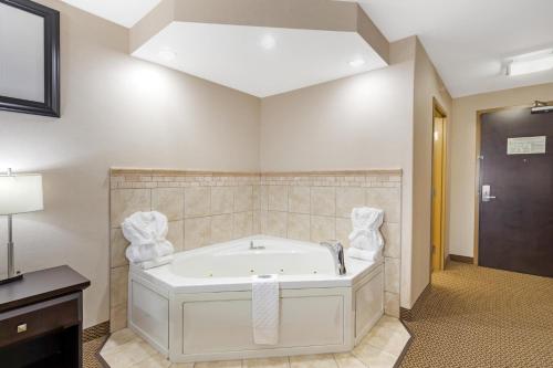 a large bathroom with a tub in a room at Best Western Bonnyville Inn & Suites in Bonnyville