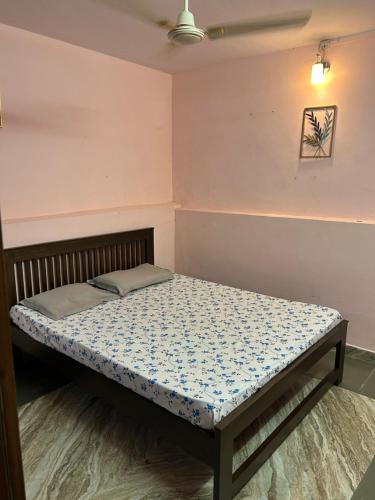 a small bed in a room with a mattressvisor at Sujata Homestay 2 in Ponda